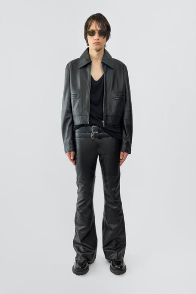 Model wearing Gable jacket in black, with a cropped cut and features front pockets. Made from recycled leather.