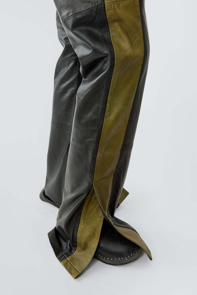 Close up of womens's Prance Leather Pants in black and olive with green stripes and slits at leg opening, made from upcycled lambskin.