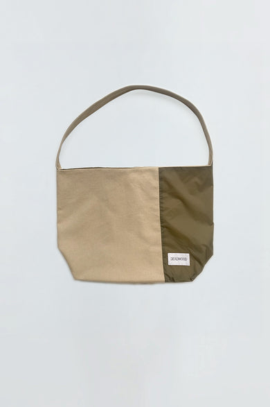 Sling Bag in Beige and Green by Deadwood, a patchwork crossbody bag crafted in Sweden with upcycled and recycled materials.