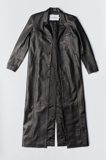 Flat view of the Vargen Coat by Deadwood, crafted from soft upcycled lambskin. It features an ultra-long silhouette, oversized fit, and a front button closure. The coat includes welt pockets at the sides, an inside pocket, and is lined with fabric made from 100% recycled plastic bottles.