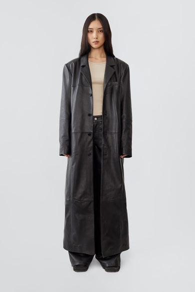 Vargen ultra-long leather coat by Deadwood, oversized fit with front button closure, crafted from upcycled lambskin.
